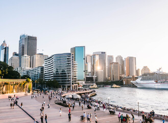 City skyline with people walking by water. Darling harbour in Sydney, Australia.