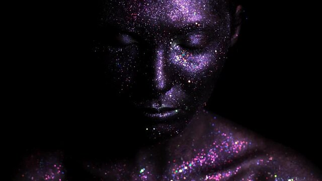 Beautyful girl with black space glitter on her face. Art image beauty face.