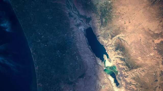 Satellite aerial view sunrise animation on Dead sea, salt lake in middle east area. Images furnished by Nasa