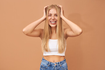 Obraz na płótnie Canvas People, lifestyle, youth and teen age. Adorable happy 18 year old European girl with facial piercing and teeth braces looking with joyful broad smile, being in good mood, expressing positive emotions