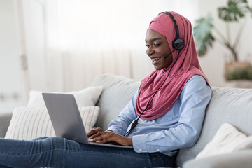 Online Learning. African Islamic Woman In Headset Stydying At Home With Laptop