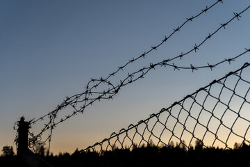 Fence with barbed wire and mesh.