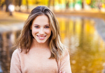 young beautiful blonde girl in beige sweater