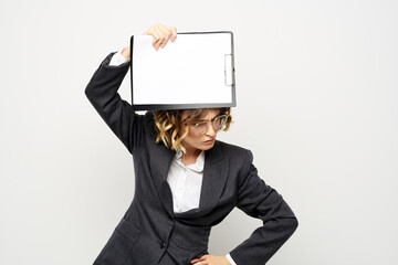 Business woman with a folder of documents on a light background cropped view and shirt suit