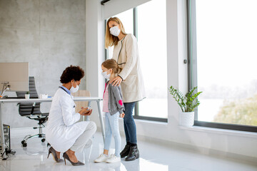 Mother with his little daughter at the pediatrician examination