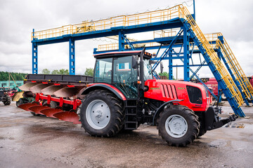 Fototapeta premium farm tractor with plow on the farm