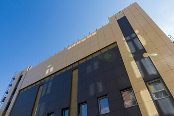 Fototapeta premium Modern construction. Vent building facade. Facing panel for the wall of a building. Facade of modern building of metal panels