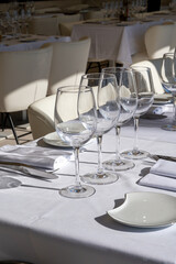 Before lunch time, empty cafes with served tables and tablecloths waiting for guests in Saint-Tropez, Provence, France