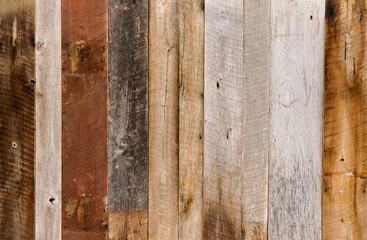 Dark stained reclaimed wood surface with aged boards lined up. Wooden floor planks with grain and texture.