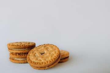 broken cookies with crumbs lies on a brown table on a white backgroundbroken cookies with crumbs lies on a brown table on a white background