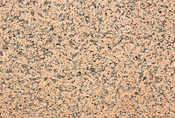 Marble texture of red granite with black inclusions.