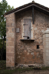 Old stone abandoned construction in the forest. Tiny forester shack