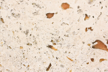 The texture of beige polished granite can serve as a model for interior repairs.Texture with spots.