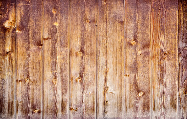 Dark stained reclaimed wood surface with aged boards lined up. Wooden floor planks with grain and texture.