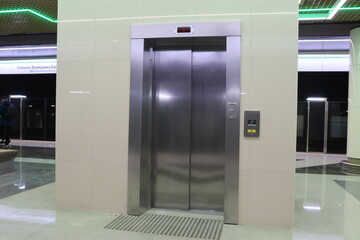 modern lift in hall with doors and symbols