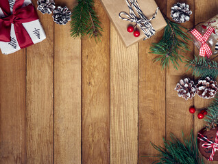 Christmas gifts with christmas decoration on wooden background.