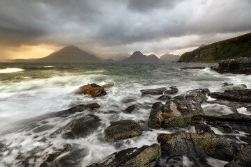 Fototapeta na wymiar Rough waves crashing on rocky shoreline at Elgol on the Isle of Skye, Scotland, UK. 