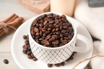 Coffee beans in a mug close-up on a light background. Side view. Concept of coffee backgrounds.