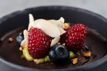 chocolate dessert with fresh wild berries raspberries and blueberries in a Cup