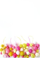 Pink and yellow balls of yarn for knitting isolated on white background. 