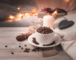Festive background with coffee, candles and lights in the background. Side view.