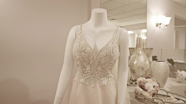 Push-in on glamorous princess wedding dress on a mannequin in a bridal suite