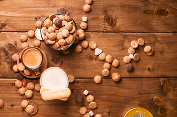Espresso coffee, milk and Traditional sweets, cookies pepernoten on a wooden table. Copy space. Dutch holiday Sinterklaas. High quality photo. top view