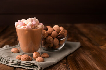 Cocoa with marshmallows and Traditional sweets, cookies pepernoten on a wooden table. Copy space. Dutch holiday Sinterklaas. High quality photo