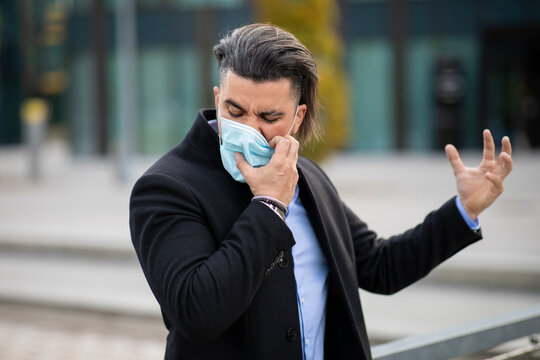 Handsome Young Man Pulling Off Corona Mask