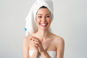 Portrait of attractive caucasian smiling woman isolated on white studio shot brushing her teeth