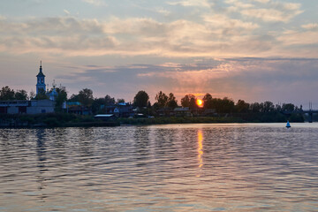 Fototapeta premium Russia. The town of Kimry. Sunset on the Volga. The sun sets over the Kimrka river