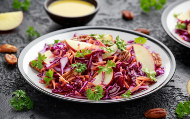 Red Cabbage salad with carrots, apples and pecan nuts. Healthy vegan food