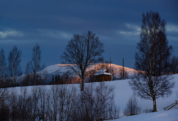 Small and quiet alpine village outskirts and winter sunrise snowy mountains around, Voronenko, Carpathian, Ukraine.