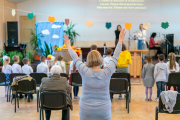 People praying in a church. soft focus of christian people group raise hands up worship God Jesus Christ together in church