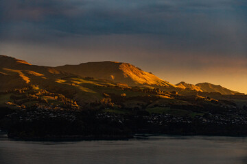 Sunset over a mountain range with a fjord in New Zealand