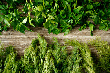 Fresh and dried dill on a wooden board and table