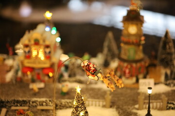 Fototapeta premium Miniature of Christmas scene old house in snow with winter concept, street, outdoor Christmas holidays