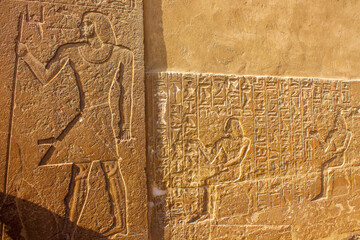 Ancient egyptian hieroglyphics on the wall of the temple