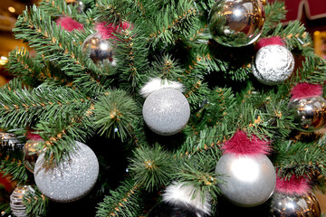 White and silver Christmas balls on the Christmas and New Year tree. Close up