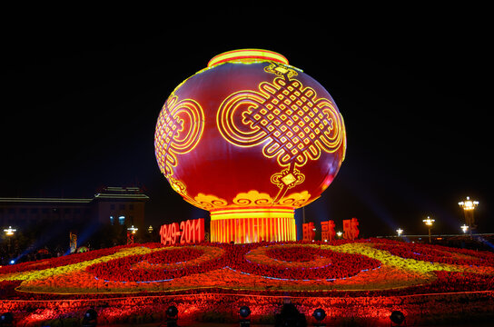 Globe and flower decorations at night National Day celebrations in Tiananmen Square with Great Hall of the People Beijing, China - October 06, 2011