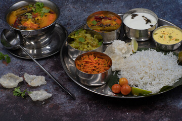 South Indian vegetarian food served in thali style on rustic table