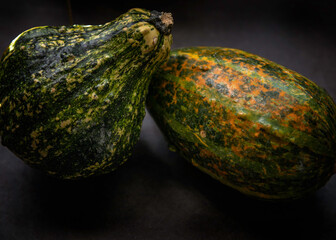 Still-life of two different gourd varieties.