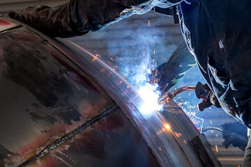 The welder is welding to steel material with gas metal arc welding proces. It sometimes referred to...