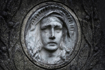 Fototapeta na wymiar Bas-relief Virgin Maria on vintage background.