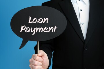 Loan Payment. Businessman holds speech bubble in his hand. Handwritten Word/Text on sign.