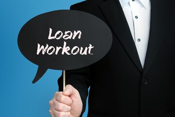 Loan Workout. Businessman holds speech bubble in his hand. Handwritten Word/Text on sign.