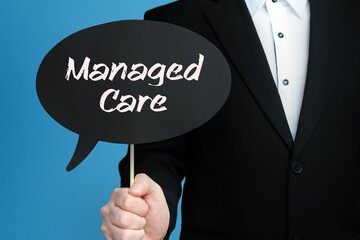 Managed Care. Businessman holds speech bubble in his hand. Handwritten Word/Text on sign.