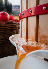 Apple juice stream closeup in apple press