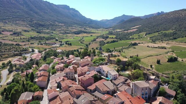 Picturesque aerial view of Cucugnan commune with main landmark 17th-century windmill, Aude department, southern France . High quality 4k footage