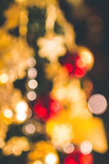 Fototapeta premium Christmas tree seasonal background, glowing multicolored lights, blurred image